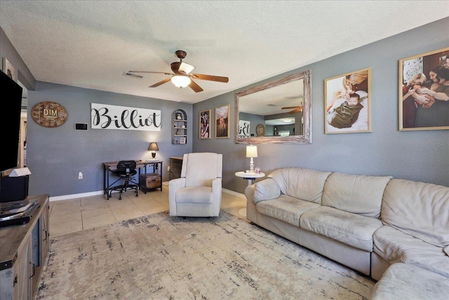 233 Spooner St, Orange, TX 77630 - living area with ceiling fan, baseboards, tile patterned floors, and a textured ceiling
