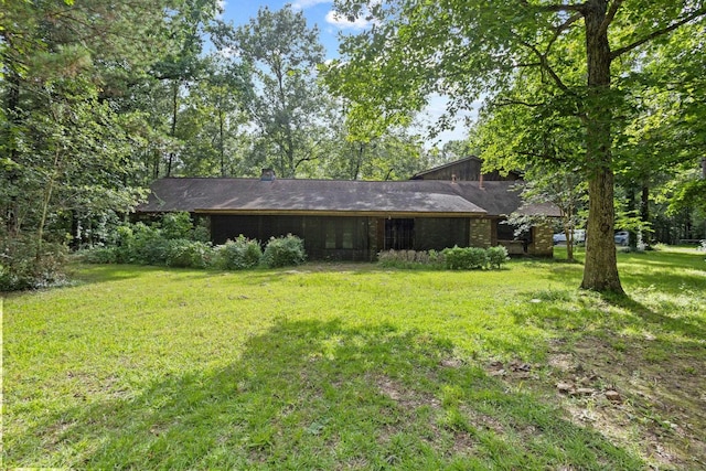 7775 River Rd, Beaumont, TX 77713 - rear view of house with a yard