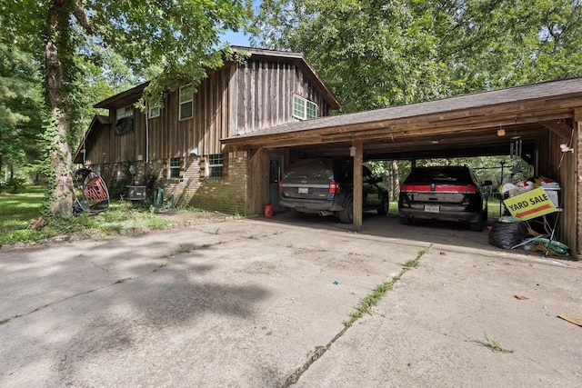 7775 River Rd, Beaumont, TX 77713 - view of property exterior featuring concrete driveway, brick siding, and an attached carport