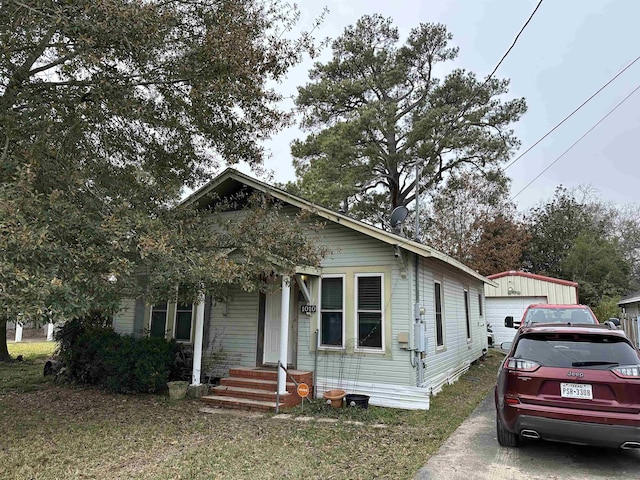 view of front of property featuring a garage and an outdoor structure