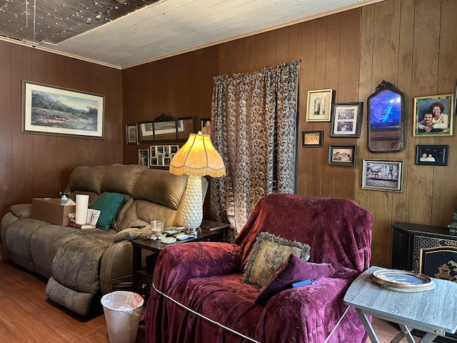 living room with hardwood / wood-style floors and wood walls