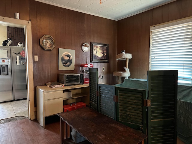 home office with crown molding and light hardwood / wood-style floors