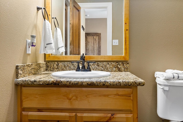 bathroom with vanity and toilet