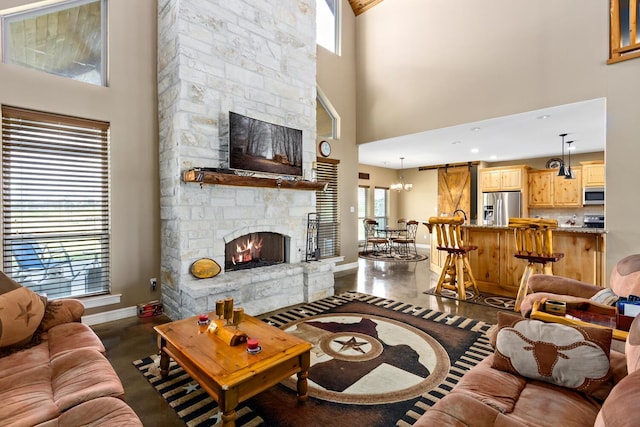 living room featuring a high ceiling and a stone fireplace