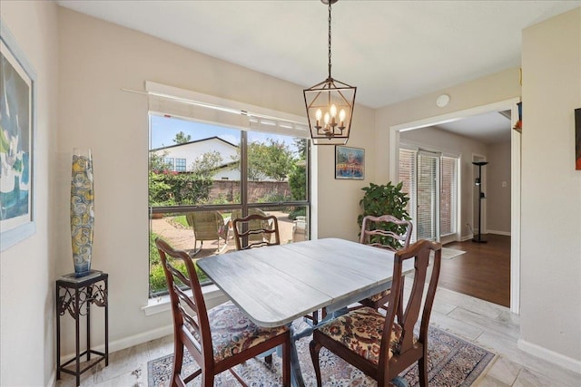 6650 Windwood Ln, Beaumont, TX 77706 - dining space with healthy amount of natural light, baseboards, and a chandelier