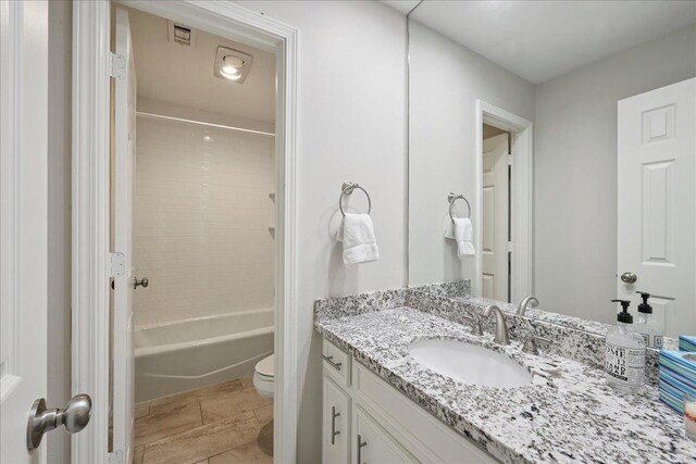 6650 Windwood Ln, Beaumont, TX 77706 - bathroom featuring vanity, toilet, and tub / shower combination