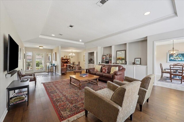6650 Windwood Ln, Beaumont, TX 77706 - living area with a raised ceiling, a chandelier, dark wood finished floors, recessed lighting, and crown molding