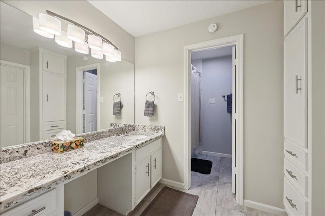 6650 Windwood Ln, Beaumont, TX 77706 - bathroom with vanity, baseboards, and marble look tile flooring