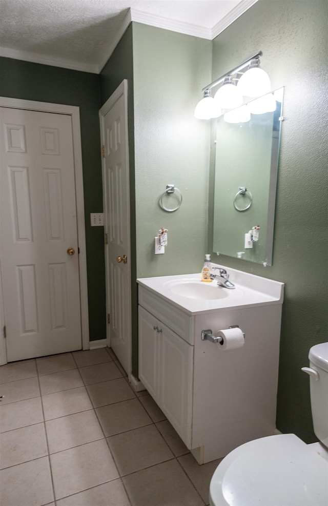 269 E Chance Rd, Lumberton, TX 77657 - bathroom featuring tile patterned floors, vanity, toilet, and ornamental molding