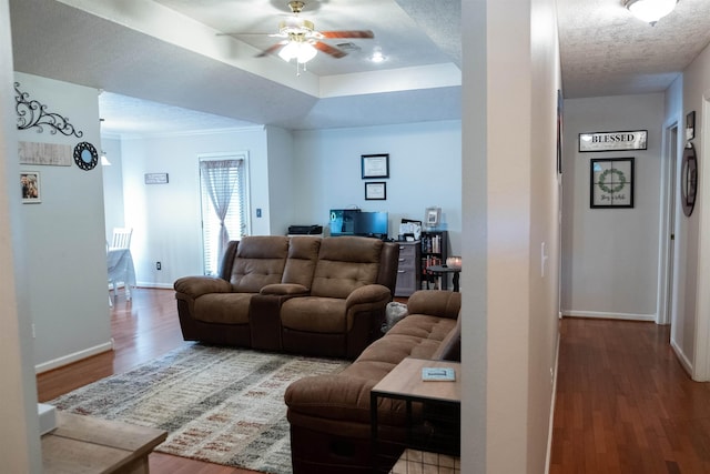 269 E Chance Rd, Lumberton, TX 77657 - living room featuring wood finished floors, a ceiling fan, baseboards, and a raised ceiling