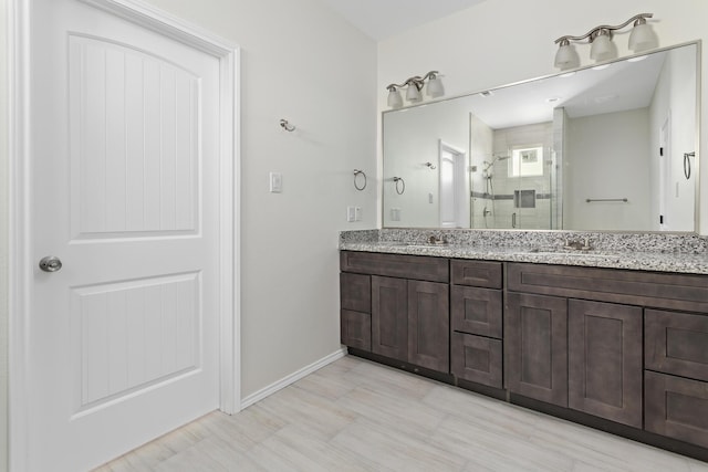 bathroom featuring an enclosed shower and vanity