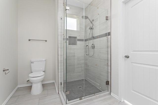 bathroom with toilet, tile patterned flooring, and a shower with shower door