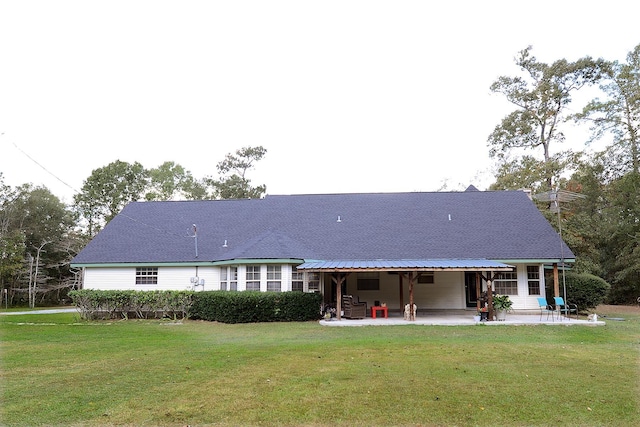 rear view of property with a patio area and a yard