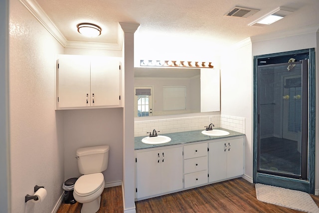 bathroom featuring a textured ceiling, hardwood / wood-style flooring, toilet, and tasteful backsplash