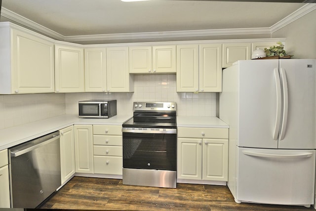 kitchen with backsplash, white cabinets, dark hardwood / wood-style floors, ornamental molding, and appliances with stainless steel finishes