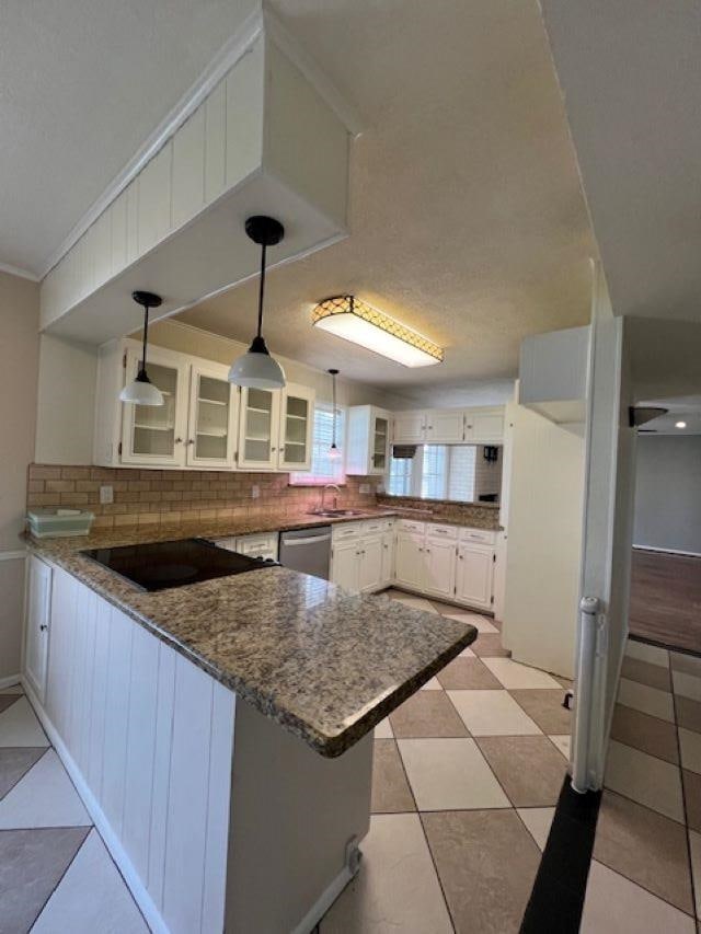 kitchen with sink, kitchen peninsula, dishwasher, black electric stovetop, and white cabinets