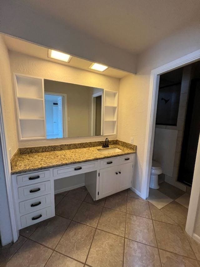 bathroom with vanity, tile patterned floors, and toilet