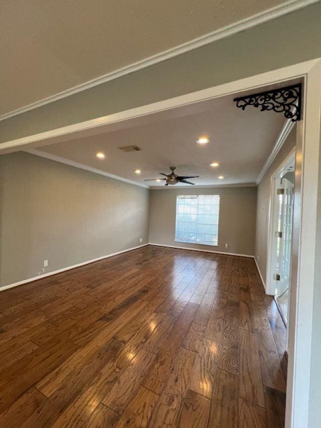 empty room with crown molding, ceiling fan, and wood-type flooring