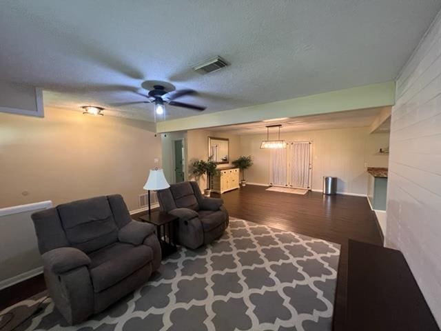 100 Cypress Bnd, Village Mills, TX 77663 - living area with wood finished floors, ceiling fan, and a textured ceiling