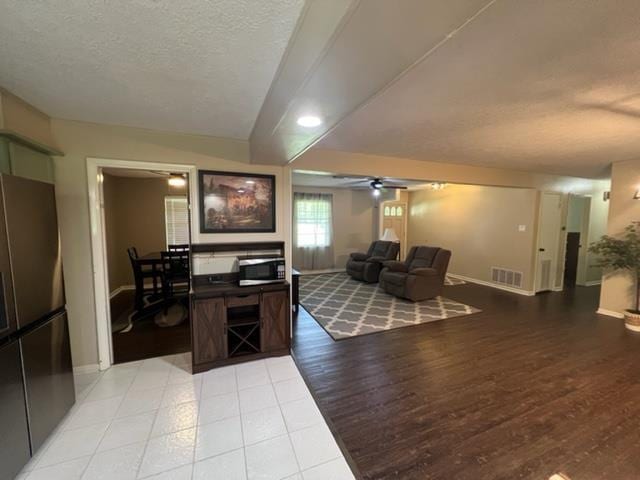 100 Cypress Bnd, Village Mills, TX 77663 - living area featuring a ceiling fan, a textured ceiling, and light wood-style floors