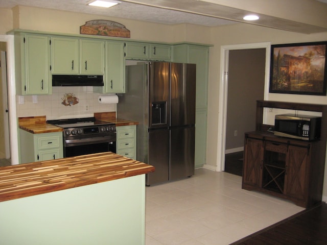 100 Cypress Bnd, Village Mills, TX 77663 - kitchen with green cabinets, appliances with stainless steel finishes, wood counters, under cabinet range hood, and backsplash
