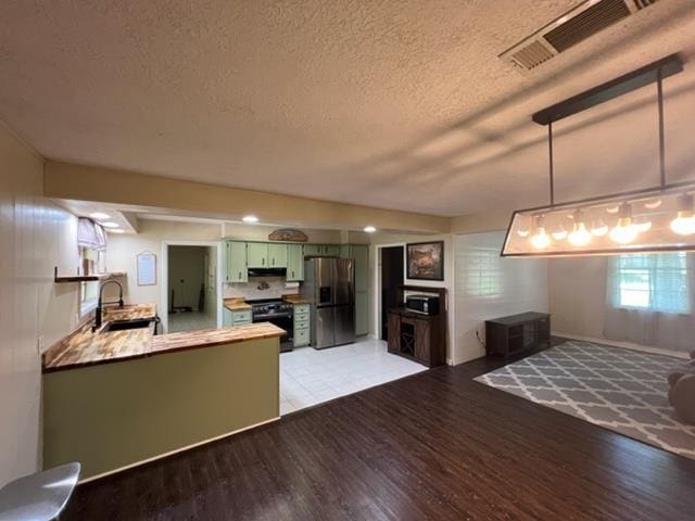 100 Cypress Bnd, Village Mills, TX 77663 - living room with a textured ceiling and light wood-style floors