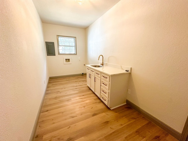 bathroom featuring electric panel, vanity, and hardwood / wood-style flooring