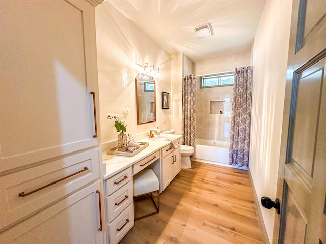 full bathroom featuring toilet, vanity, shower / bath combination with curtain, and hardwood / wood-style flooring