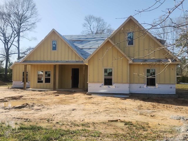 rear view of property featuring board and batten siding