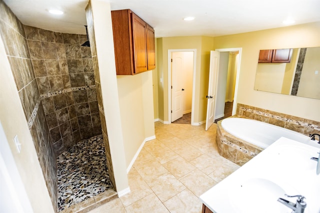 bathroom with plus walk in shower, tile patterned floors, and vanity