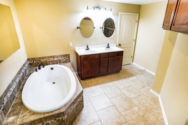 bathroom with vanity, tile patterned floors, and tiled bath