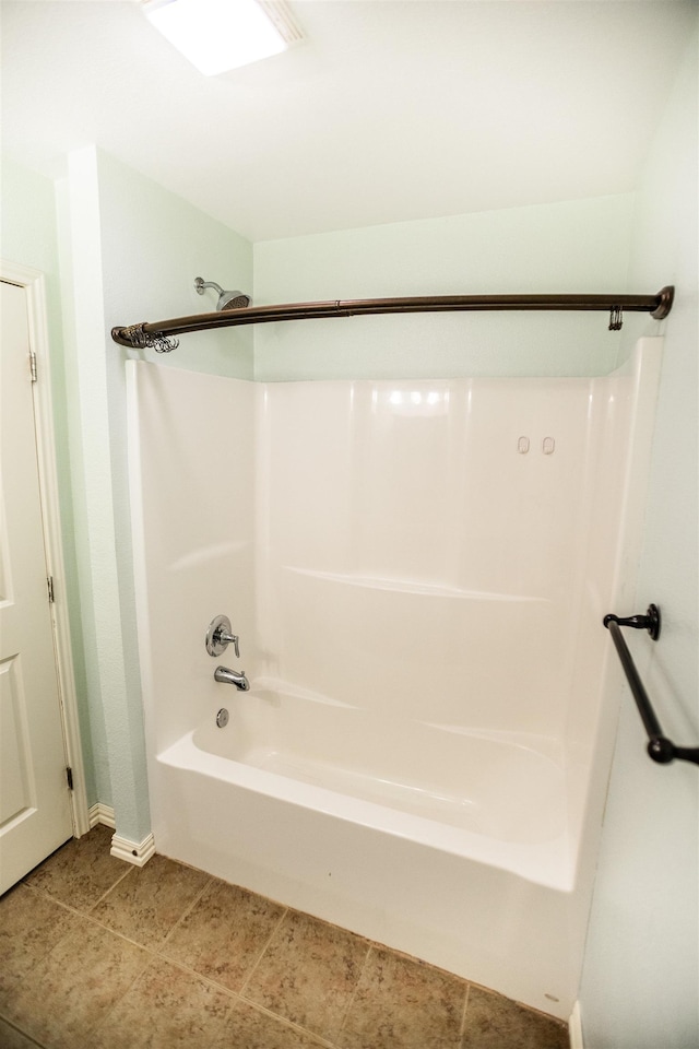 bathroom with tile patterned floors and  shower combination