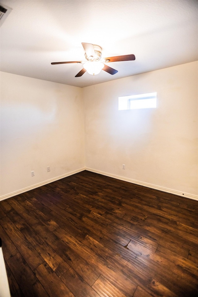 empty room featuring ceiling fan and dark hardwood / wood-style flooring