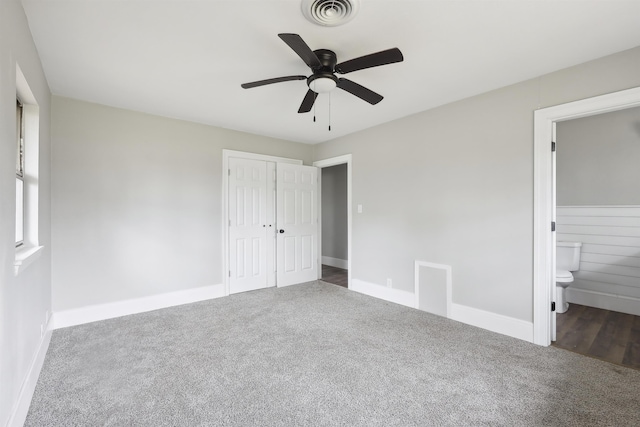 unfurnished bedroom with visible vents, connected bathroom, carpet floors, a closet, and baseboards