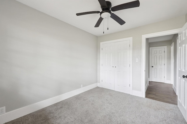 unfurnished bedroom with baseboards, a ceiling fan, carpet flooring, and a closet