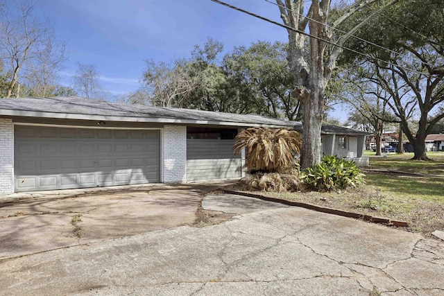 garage with concrete driveway