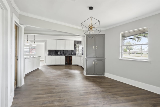kitchen with a chandelier, tasteful backsplash, ornamental molding, and a healthy amount of sunlight