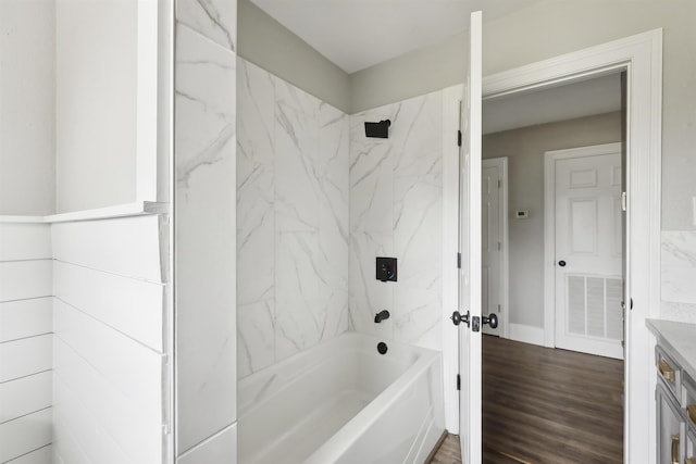 full bathroom with vanity, wood finished floors, visible vents, and bathing tub / shower combination