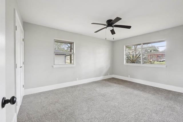 spare room with carpet floors, a wealth of natural light, and a ceiling fan
