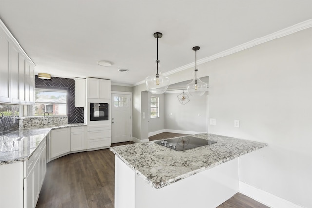 kitchen with dark wood finished floors, white cabinetry, ornamental molding, and black appliances