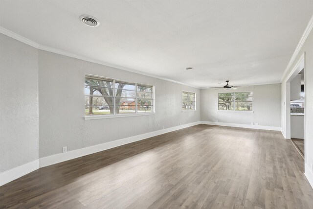 unfurnished living room featuring a ceiling fan, baseboards, ornamental molding, and visible vents
