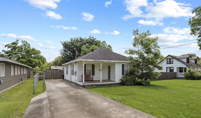 815 N 14th St, Nederland, TX 77627 - view of front of home with a porch, driveway, and a gate