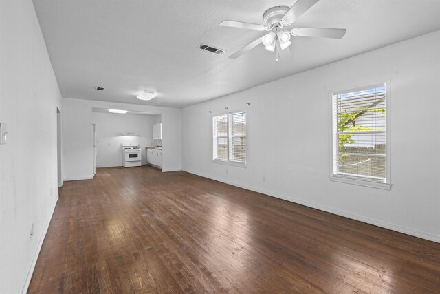 815 N 14th St, Nederland, TX 77627 - unfurnished living room with dark wood finished floors, a ceiling fan, and baseboards