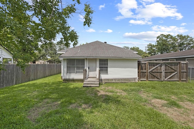 815 N 14th St, Nederland, TX 77627 - back of house with entry steps, a shingled roof, and a gate