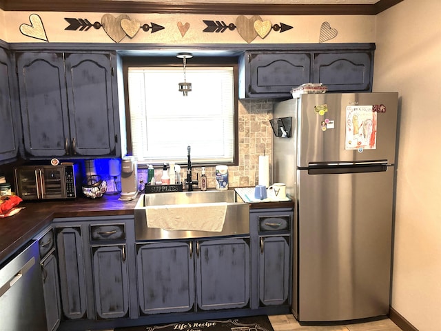 kitchen with sink, backsplash, and stainless steel appliances