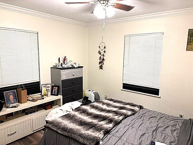 bedroom with ceiling fan, ornamental molding, and dark hardwood / wood-style flooring