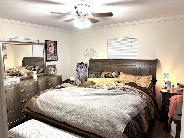 bedroom with hardwood / wood-style flooring, ornamental molding, and ceiling fan