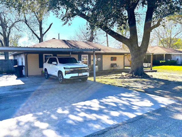 ranch-style house featuring a carport