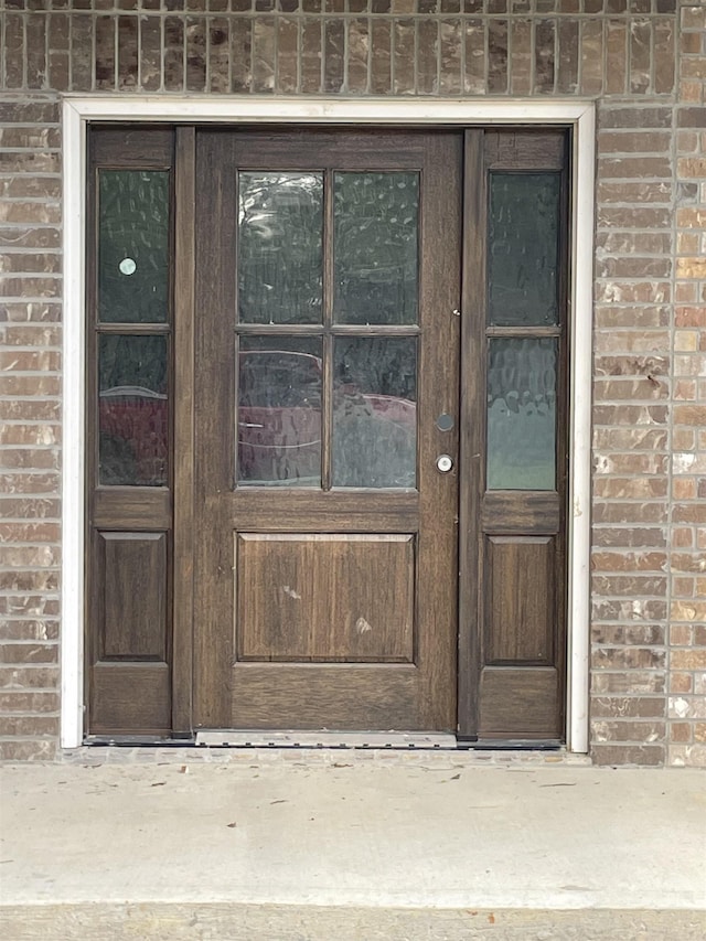 property entrance with brick siding