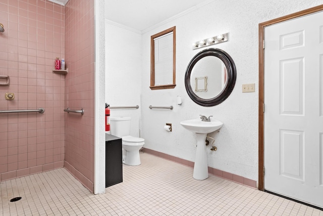 134 Sherwood Trl, Silsbee, TX 77656 - full bath featuring toilet, ornamental molding, tiled shower, tile patterned floors, and baseboards